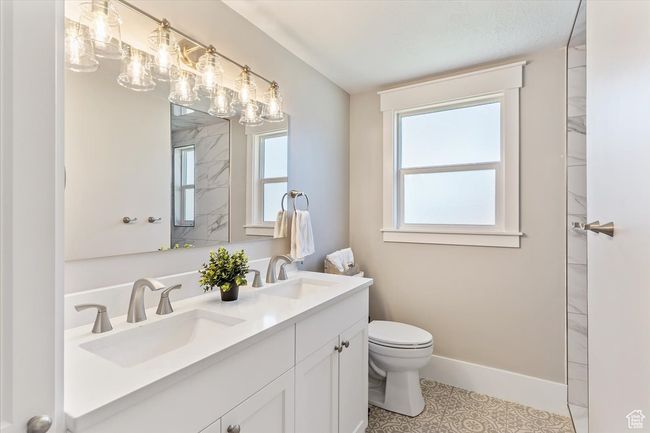 Full bath featuring double vanity and plenty of natural light | Image 25