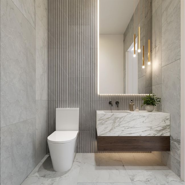 Bathroom featuring tile walls, marble tiled flooring, vanity, and toilet | Image 5