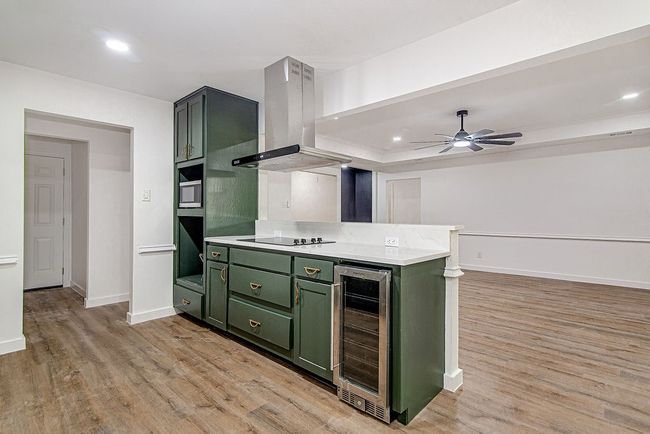 Kitchen featuring green cabinetry, wine cooler, light wood-style flooring, and recessed lighting, oven will be installed on 6/12 | Image 16