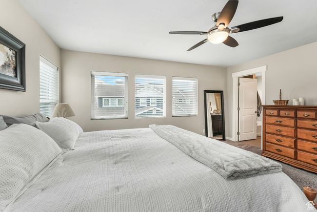 Bedroom featuring ceiling fan and carpet | Image 14