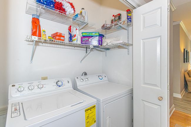 Laundry room featuring independent washer and dryer, laundry area, and light wood-type flooring | Image 32