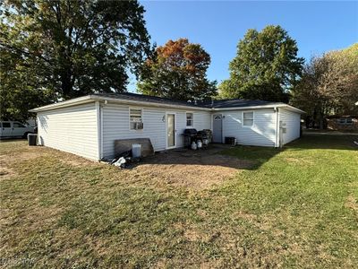 Back of property featuring cooling unit and a lawn | Image 2