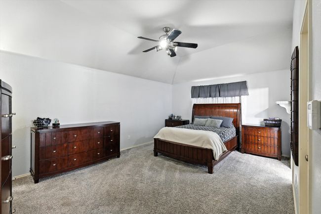 Carpeted bedroom with vaulted ceiling and ceiling fan | Image 8