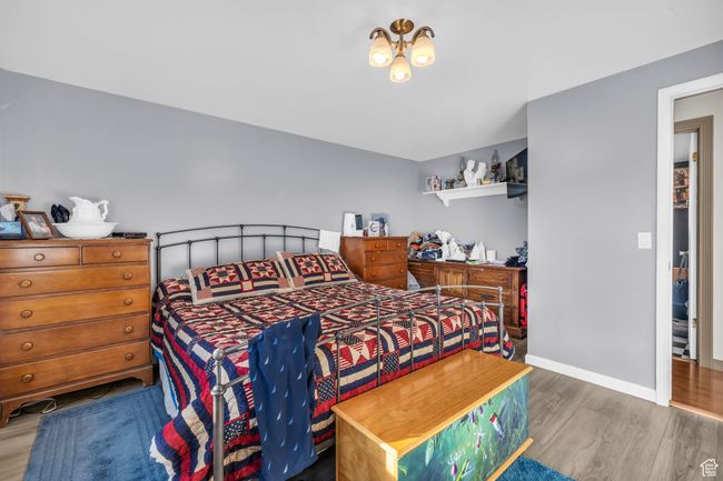 Bedroom featuring baseboards and wood finished floors | Image 13