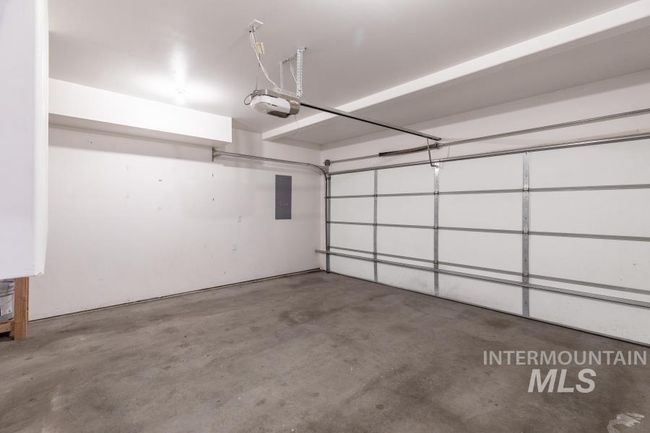 Garage with electric panel and a garage door opener | Image 24