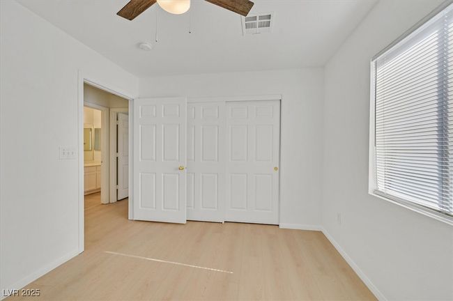 Unfurnished bedroom featuring light wood finished floors, a ceiling fan, and a closet | Image 15