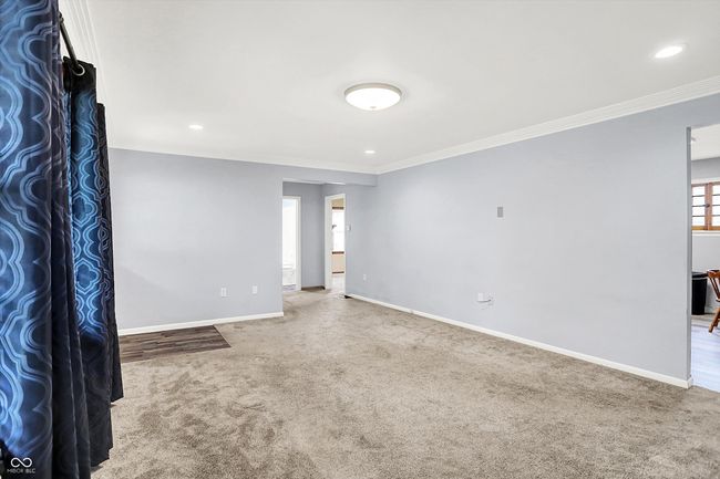 unfurnished room with carpet, crown molding, baseboards, and recessed lighting | Image 5