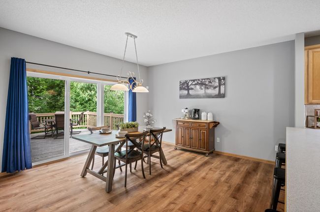 Formal dining area has an extra large sliding door, leading out to the deck, and private back yard. | Image 12