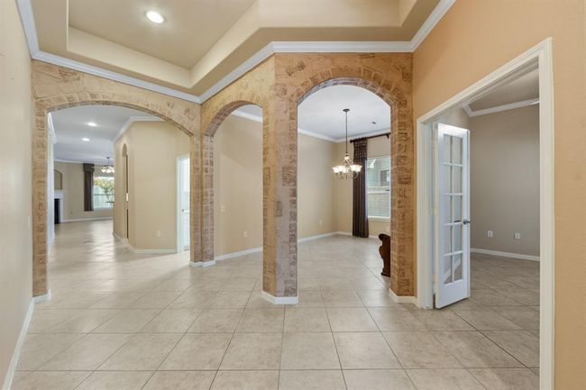 The entry boasts elegant tile flooring that flows seamlessly throughout the home. | Image 8