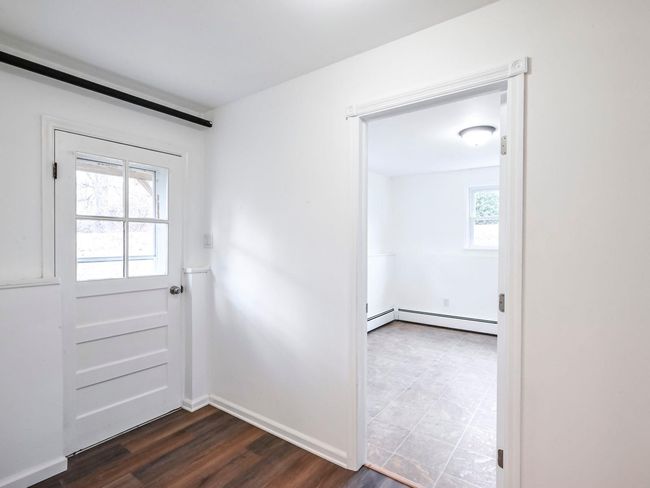 Doorway to outside featuring dark hardwood / wood-style flooring and baseboard heating | Image 20