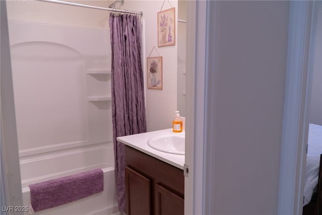 Full bathroom featuring shower / tub combo with curtain and vanity | Image 19