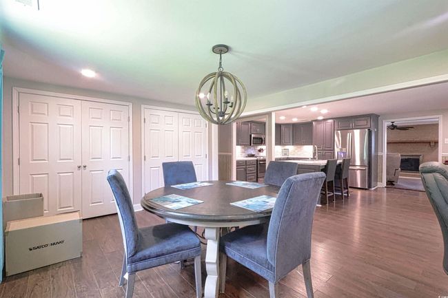 Dining room featuring a chandelier, recessed lighting, and dark wood-type flooring | Image 14