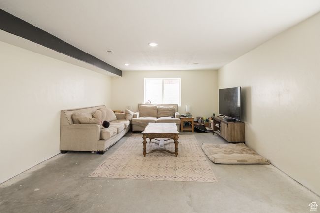 Living room featuring unfinished concrete floors and recessed lighting | Image 18
