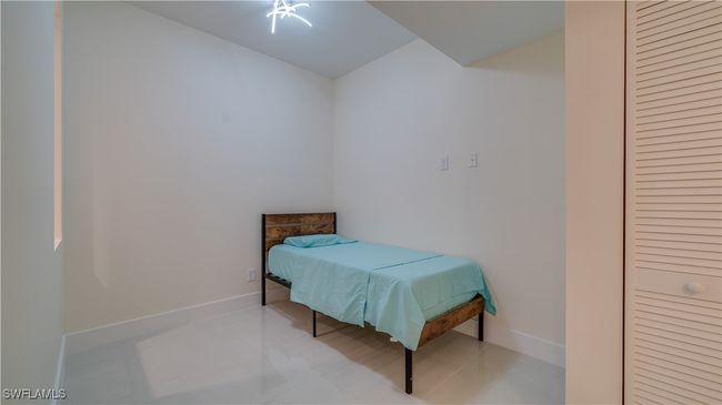 Bedroom with light tile patterned floors | Image 17