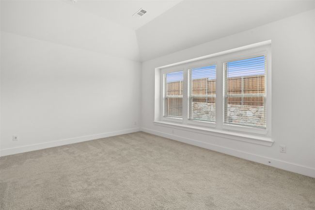 Empty room featuring baseboards, carpet floors, visible vents, and vaulted ceiling | Image 24