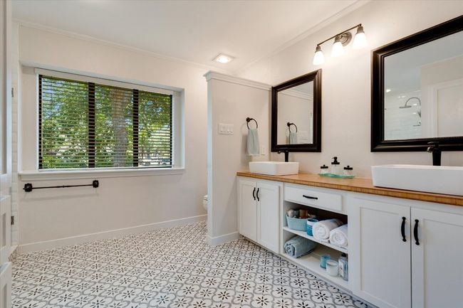 Bathroom featuring double vanity, tile flooring, crown molding, toilet, and baseboards | Image 21