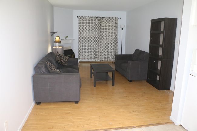 Living area with light wood finished floors and baseboards | Image 12