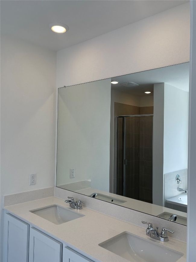 Bathroom with double vanity, a stall shower, recessed lighting, and a garden tub | Image 13