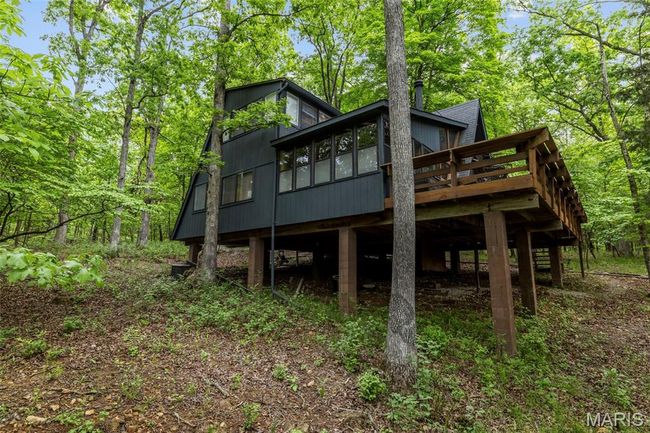 Back of house featuring a wooden deck and a sunroom | Image 65