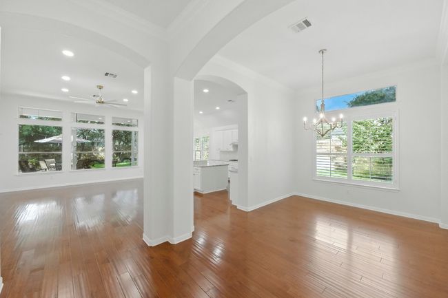 View from large entry hall into dining room, kitchen and family room. So open and perfect for entertaining. | Image 18