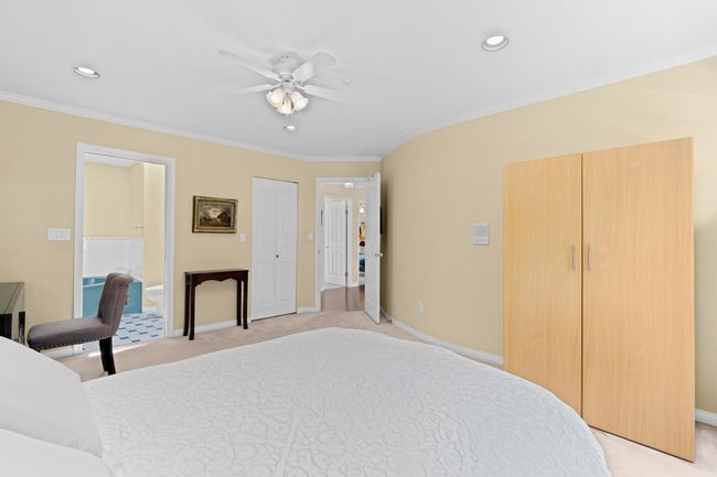Bedroom with crown molding, light colored carpet, recessed lighting, a ceiling fan, and connected bathroom | Image 27