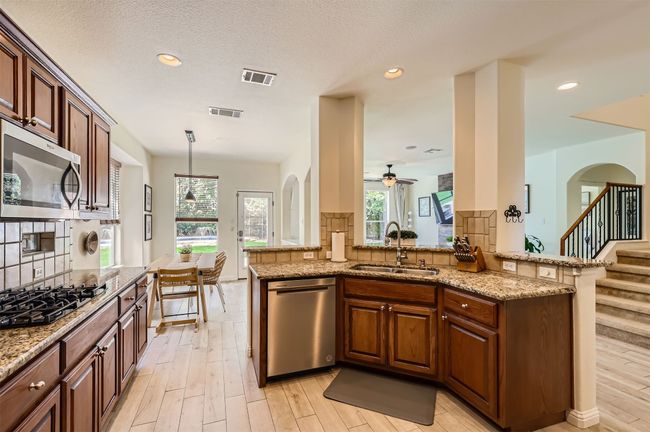 Watch the kids play while enjoying the open flow from kitchen to living spaces. | Image 10