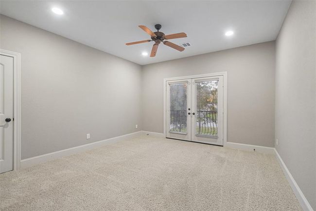 Enjoy serene views from the charming balcony accessible directly from this large front-facing bedroom. | Image 32