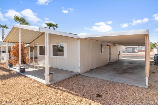 View of side of property featuring an attached carport | Image 34