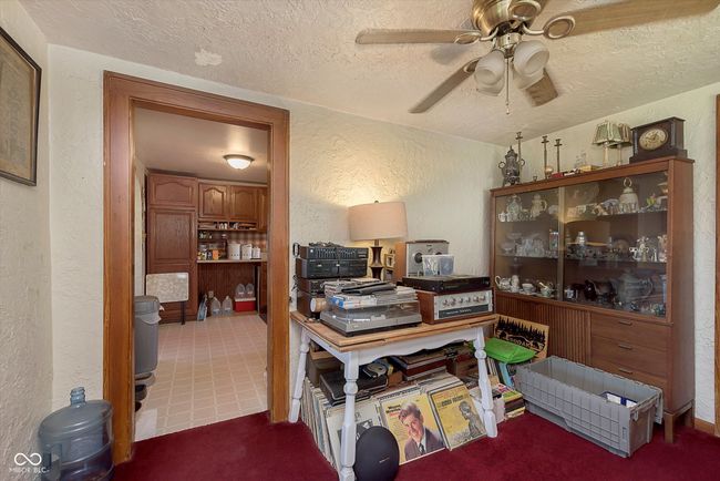office area with a textured wall, a textured ceiling, and ceiling fan | Image 9