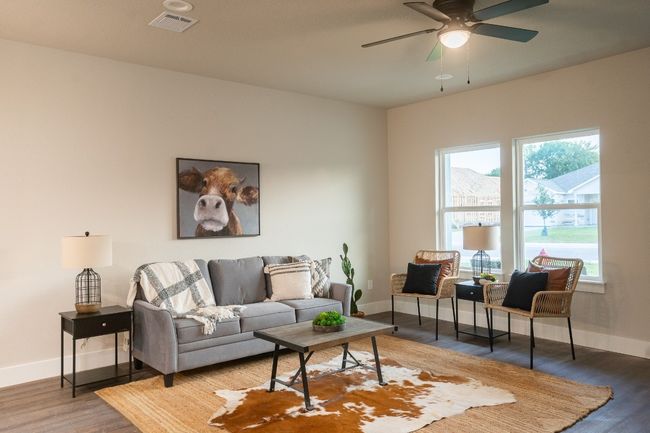 Living area featuring baseboards, wood finished floors, and ceiling fan | Image 4