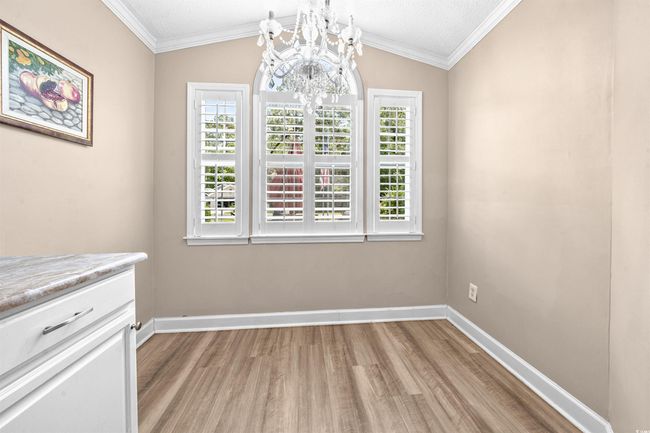 Unfurnished dining area featuring baseboards, plenty of natural light, and light wood-style flooring | Image 24