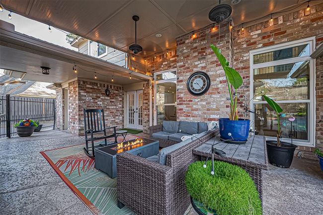 Discover your private oasis with a covered patio, sparkling pool, and easy-care turf lawn. | Image 43