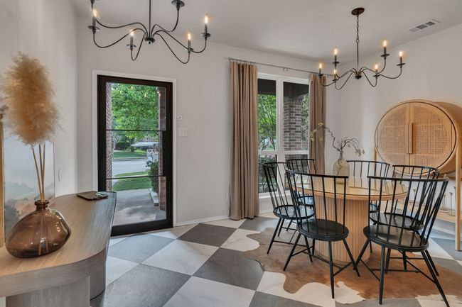 Dining room featuring a chandelier and healthy amount of natural light | Image 5