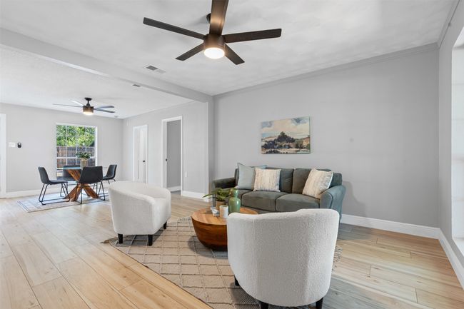 Living room featuring a ceiling fan and light wood-style floors | Image 8