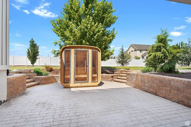Fenced backyard with a patio | Image 31