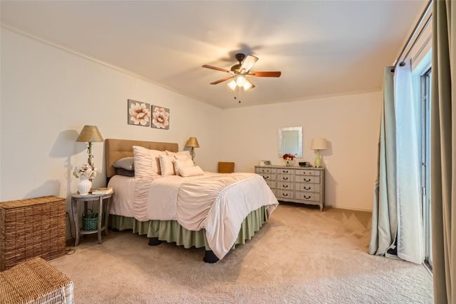 Bedroom with light carpet, crown molding, and ceiling fan | Image 13
