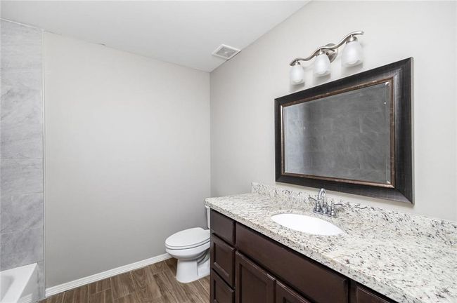 Full bath with vanity and wood finished floors | Image 9