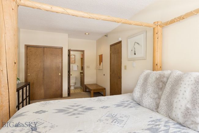 Bedroom featuring a textured ceiling and ensuite bath | Image 10