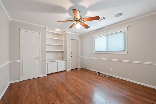 At the top of the stairs on the left is the first bedroom, complete with built ins and walk in closet. | Image 25