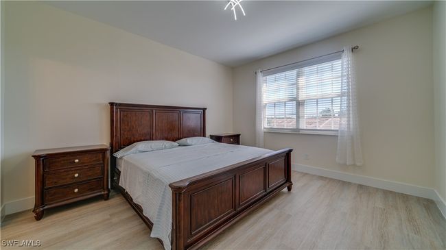 Bedroom with light hardwood / wood-style floors | Image 4