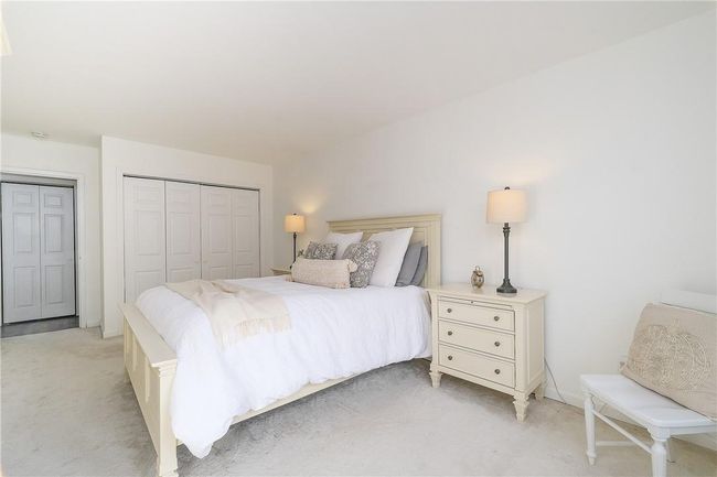 View of bedroom showing closet in background. | Image 27