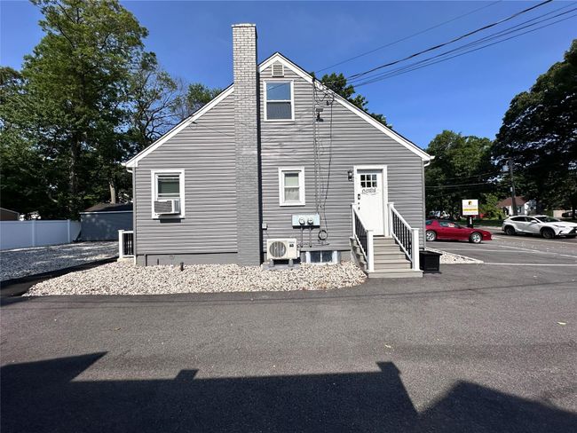 View of side of home featuring entry steps and a chimney | Image 9