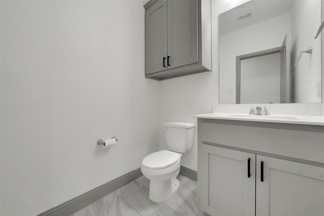 Half bath with vanity, visible vents, toilet, marble finish floor, and baseboards | Image 19