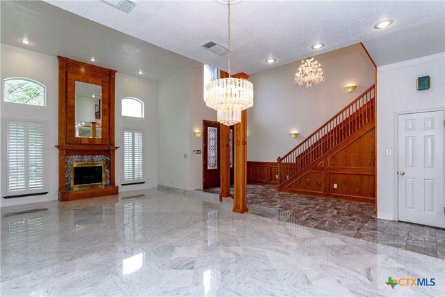 Dining area featuring a gorgeous chandelier | Image 10
