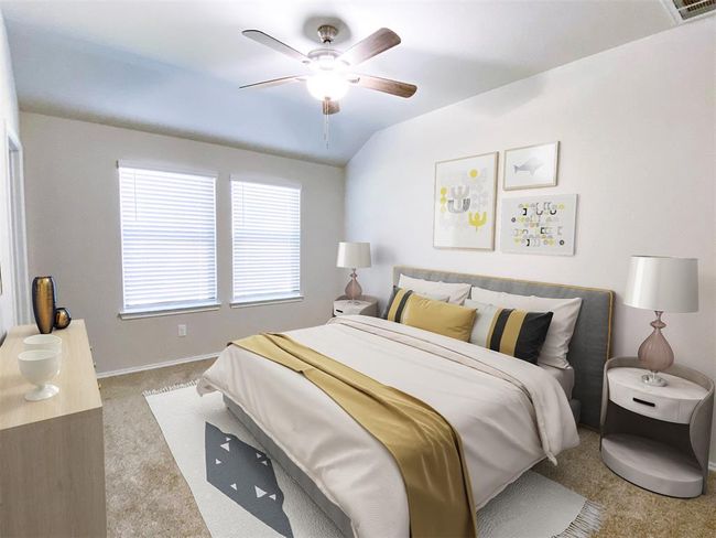 This bedroom is bright and inviting, featuring room for your comfortable bed with stylish bedding, two bedside tables with lamps, and a ceiling fan. Two large windows provide ample natural light, complementing the neutral ambiance. | Image 5