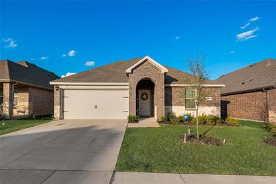 View of front of house featuring a front lawn and a garage | Image 1