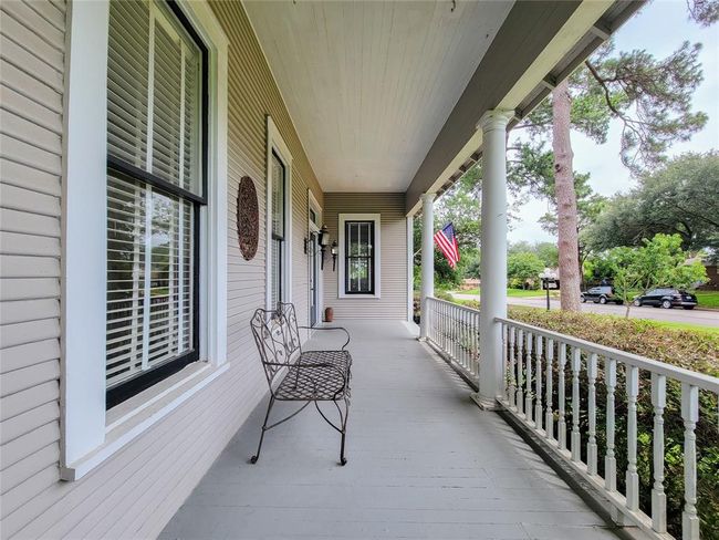 Expansive 25ft covered front porch, perfect for relaxing in rocking chairs and enjoying the tranquility of nature. | Image 6