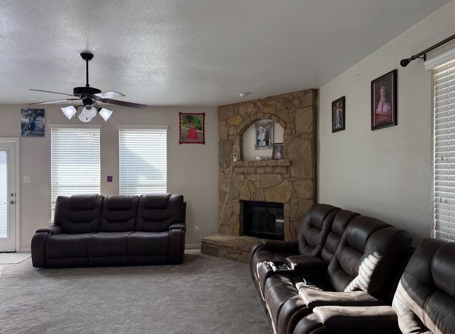 View of open floor plan with great fireplace, and natural lights all throughout. | Image 13