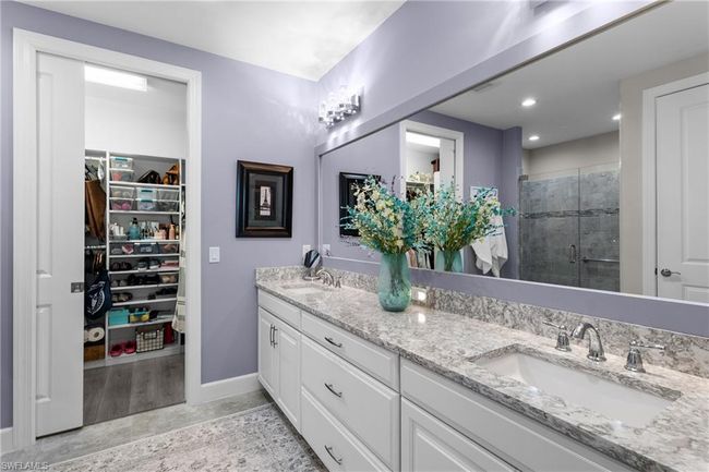 Full bathroom with double vanity, a shower stall, a walk in closet, and recessed lighting | Image 18