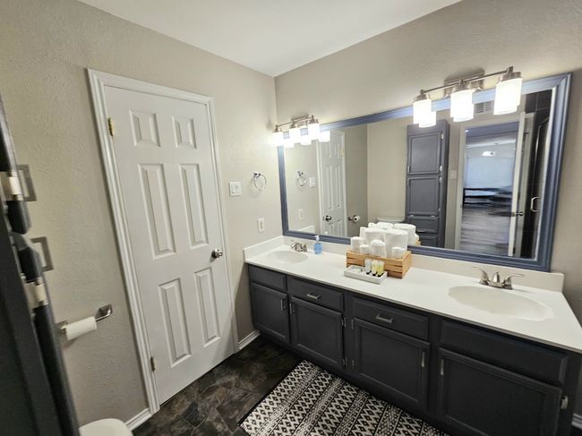 Full bath with double vanity and baseboards | Image 11